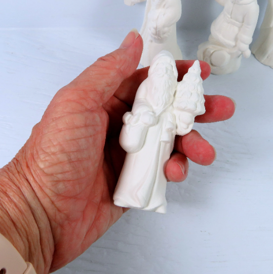 handmade ready to paint ceramic santa statues with one in my hand