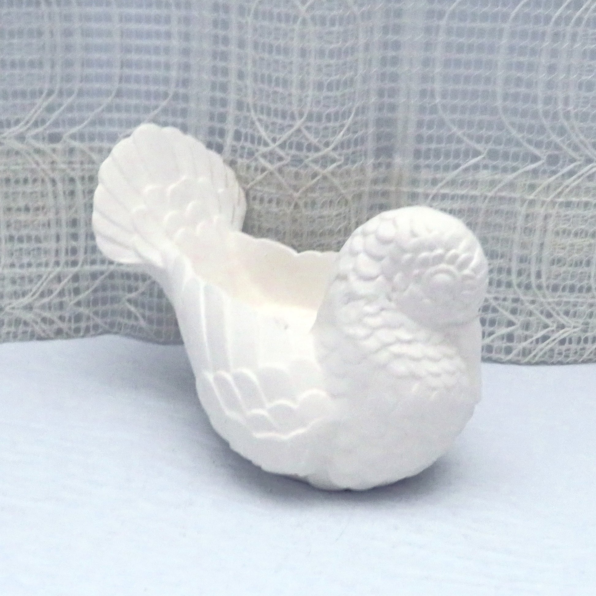 Ready to Paint ceramic bird facing at an angle toward the right.  His beak is tucked into his breast.