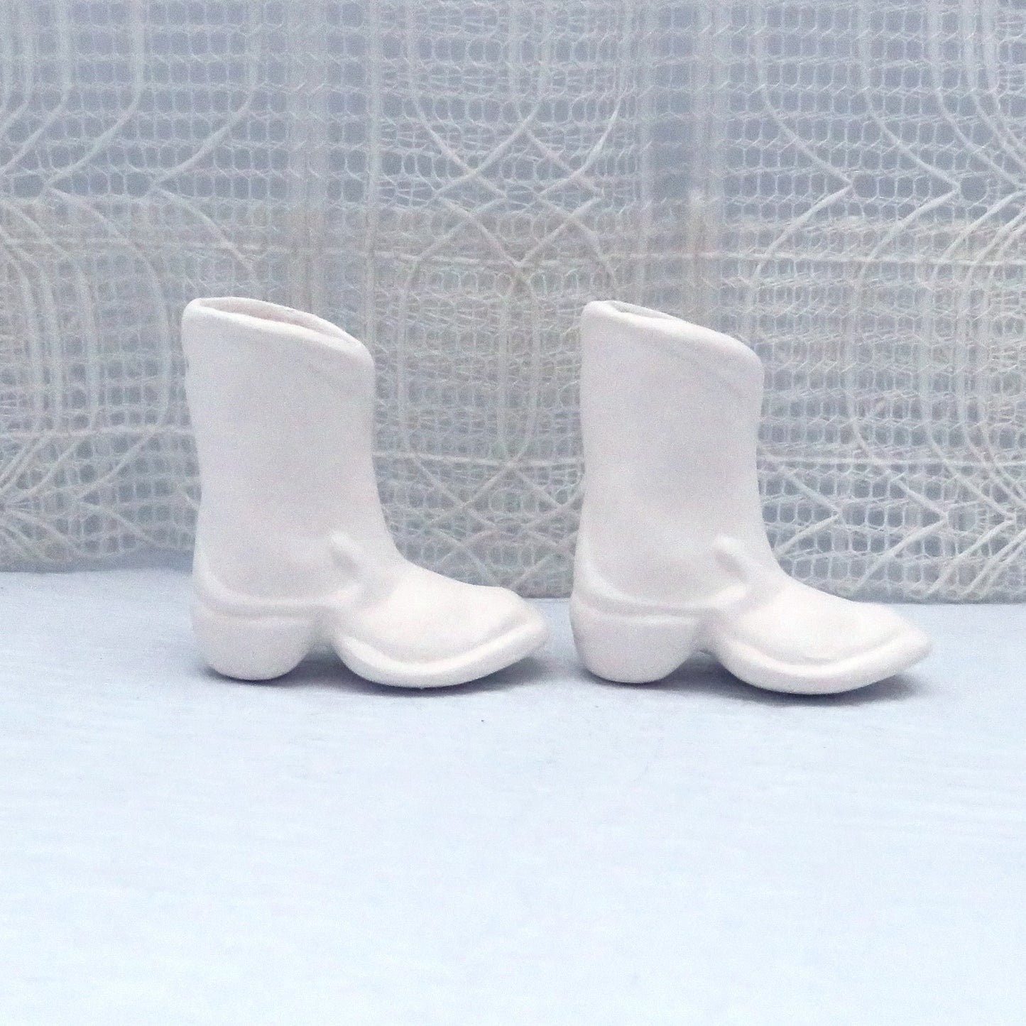 1 set of 2 ready to paint ceramic boots with toes to the right