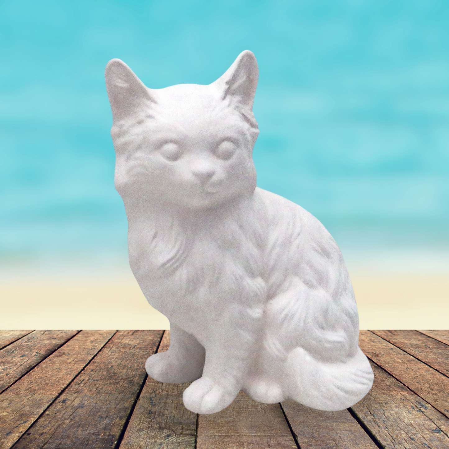 Handmade ceramic ready to paint Sitting Persian cat facing forward with its tail curled around to the front. He is sitting on a table near the ocean. This photo shows the texture of the cat.
