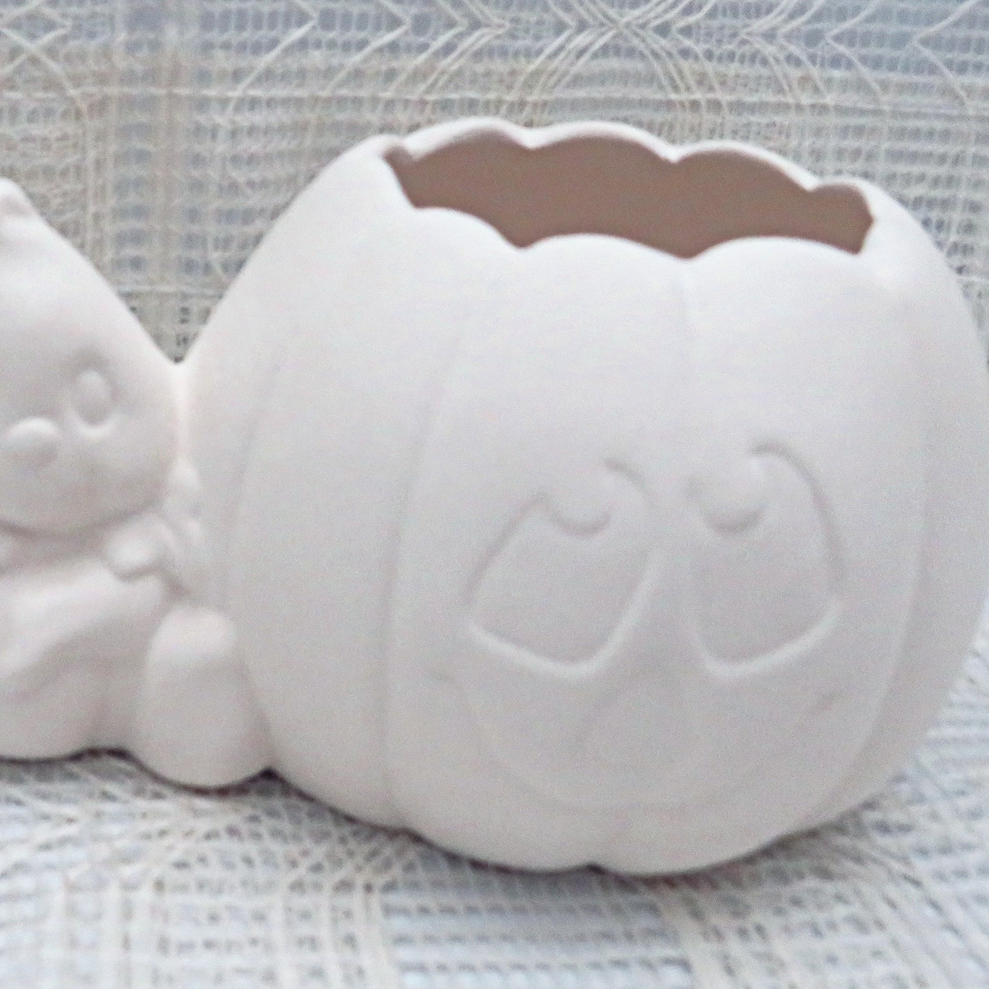 Paintable ceramic pumpkin showing close up of pumpkin face.