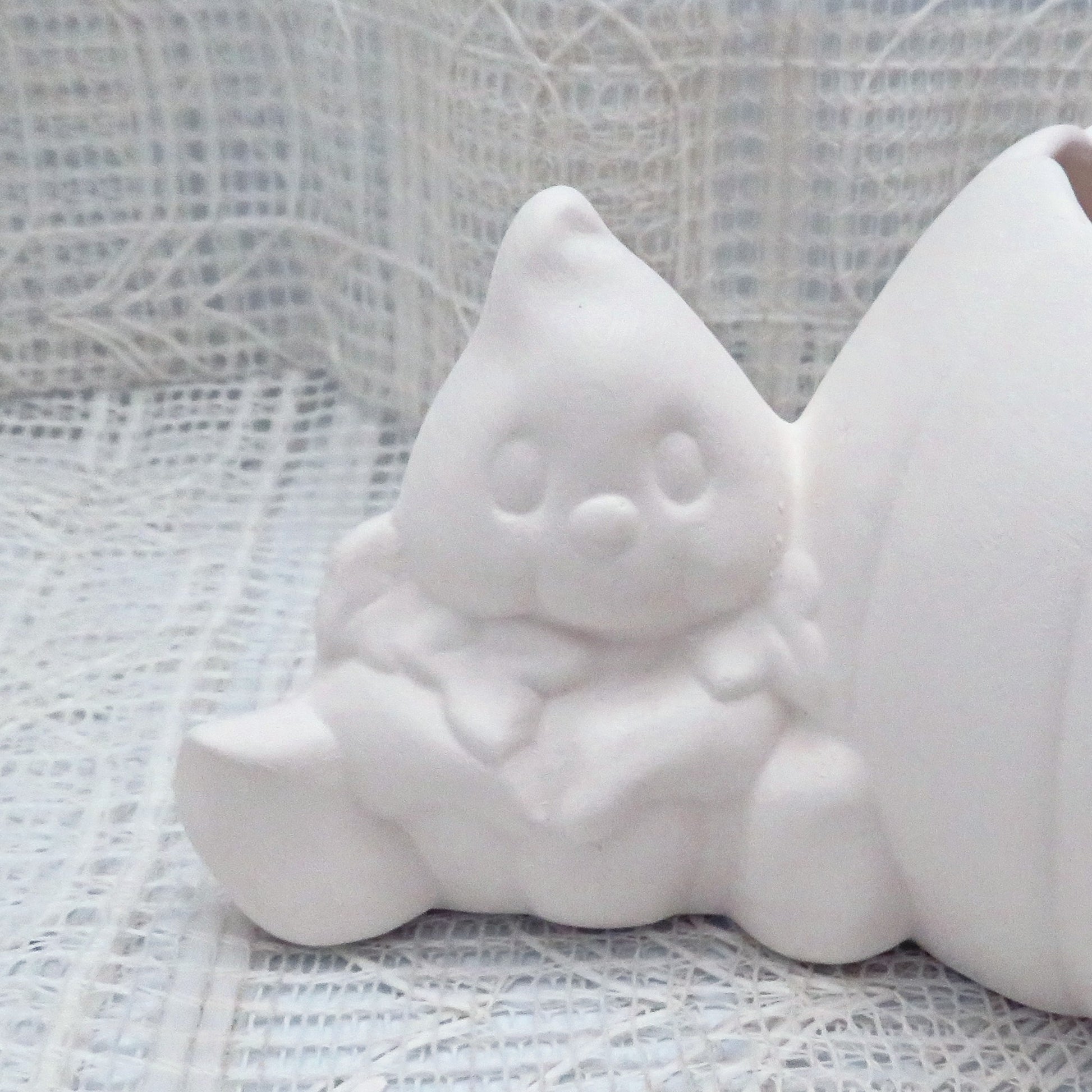 Handmade paintable pumpkin and ghost focusing on the ghost.