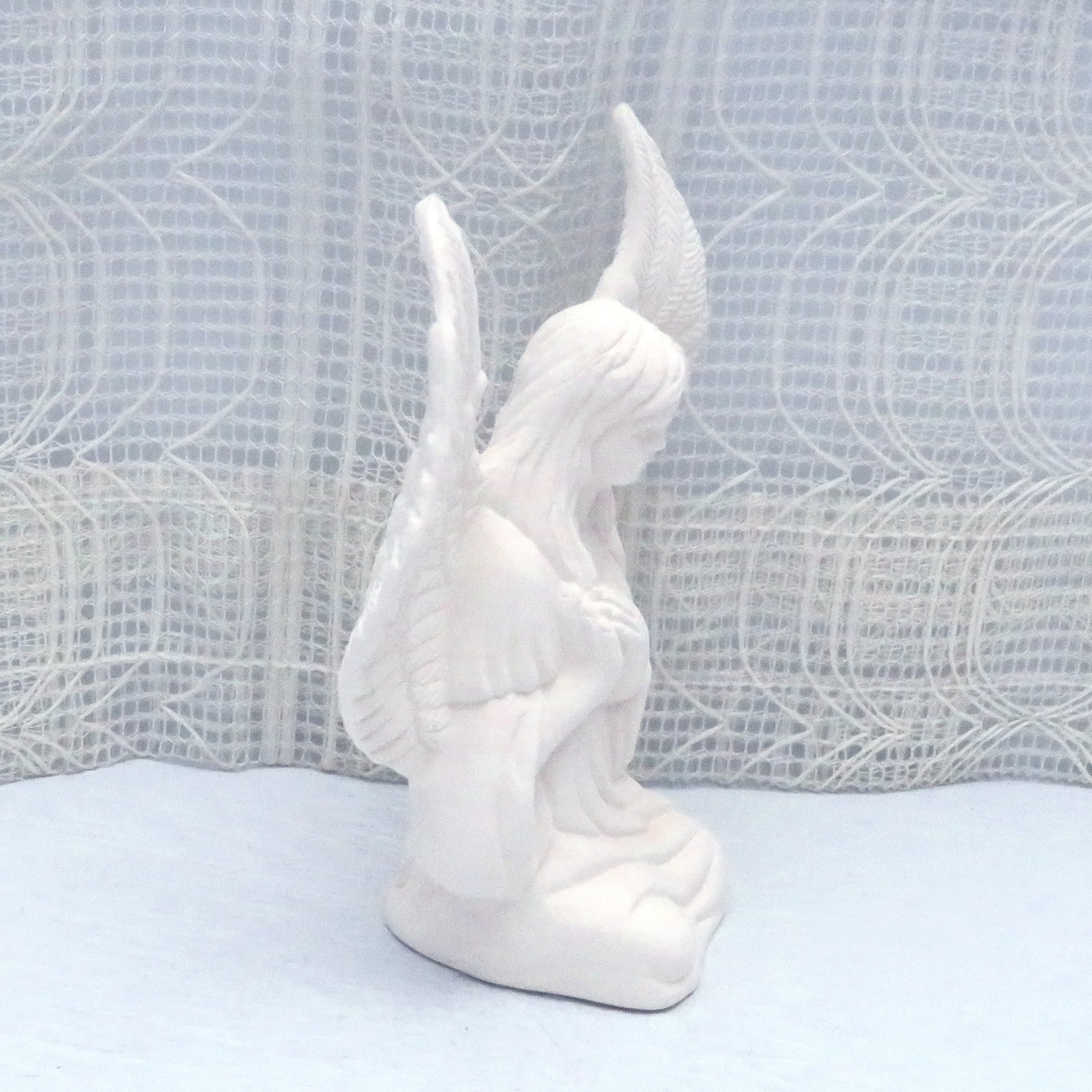 Side view of paintable ceramic angel statue facing right