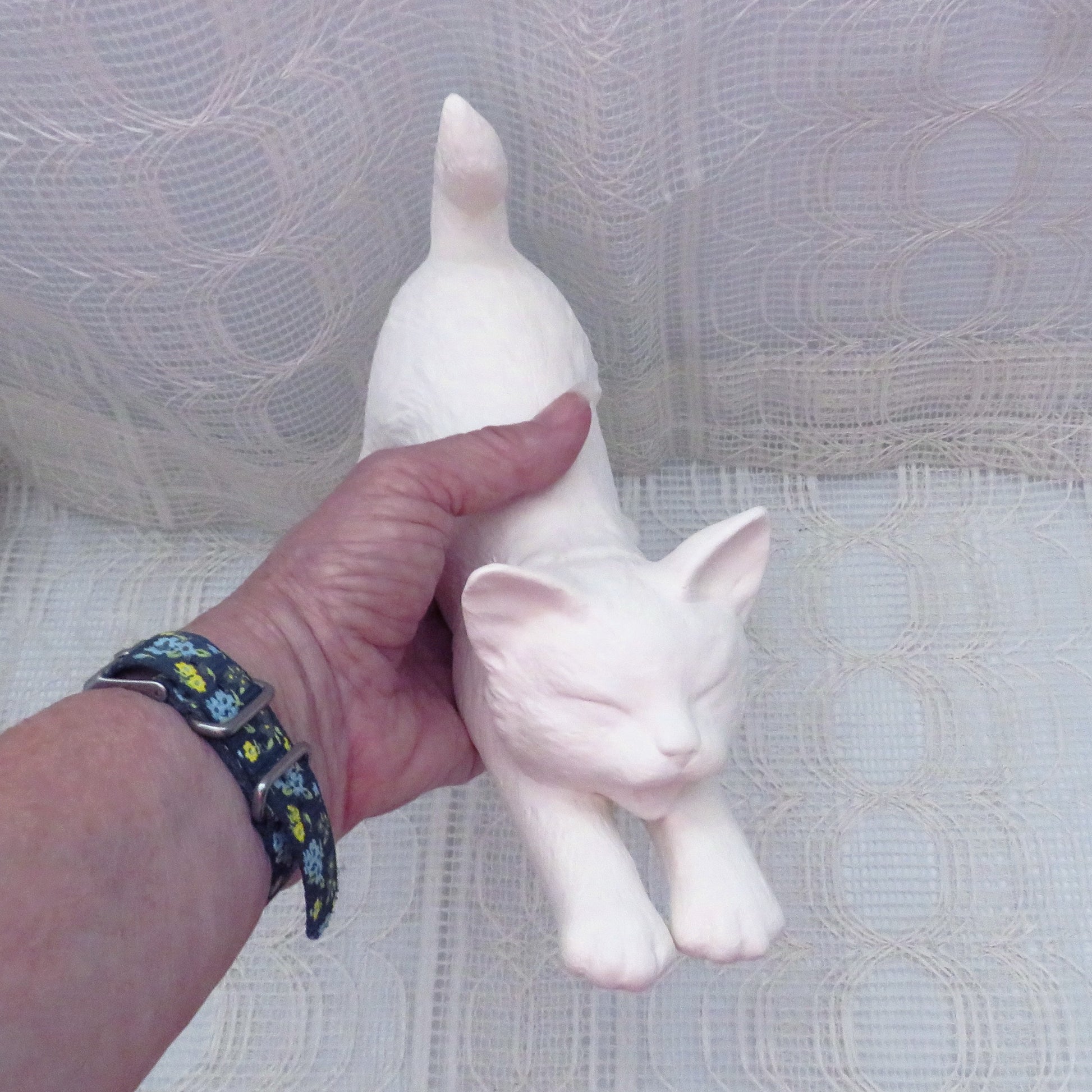 Unpainted Ceramic cat statue in my hand for size illustration.