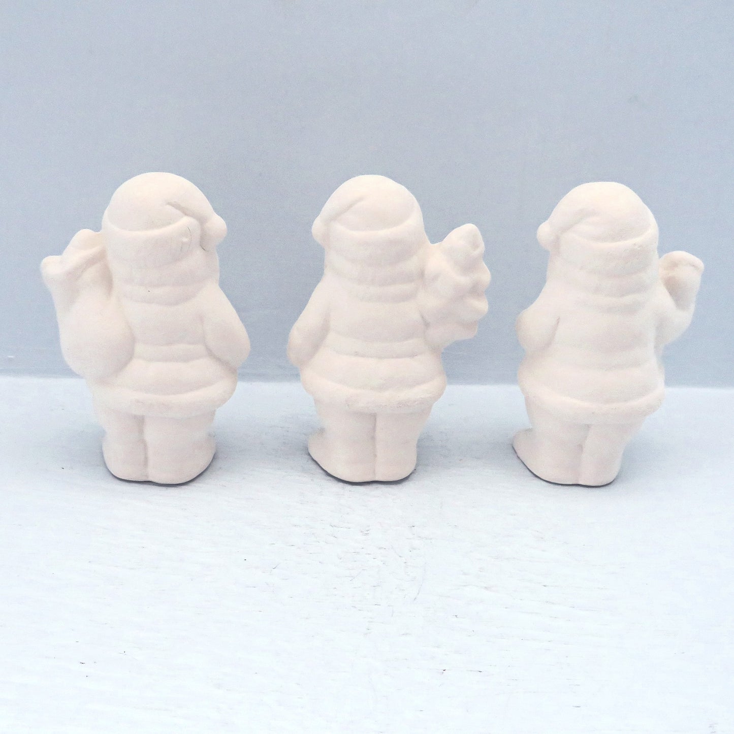 Rear view of the santa clauses. The bag of toys is more visible on one of them.