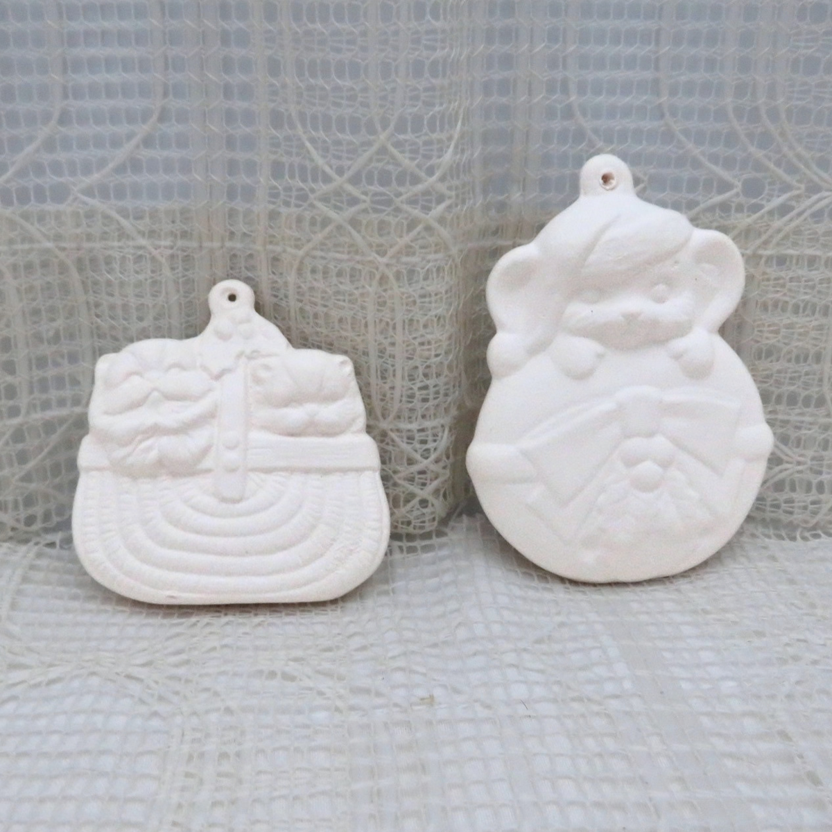 Ready to paint ceramic Christmas tree ornaments.  One is 2 little cats in a basket.  The other is a mouse with a hat on holding on to an ornament.
