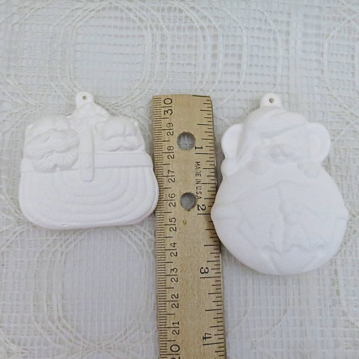 DIY ceramic christmas tree ornaments near a ruler to illustrate size.