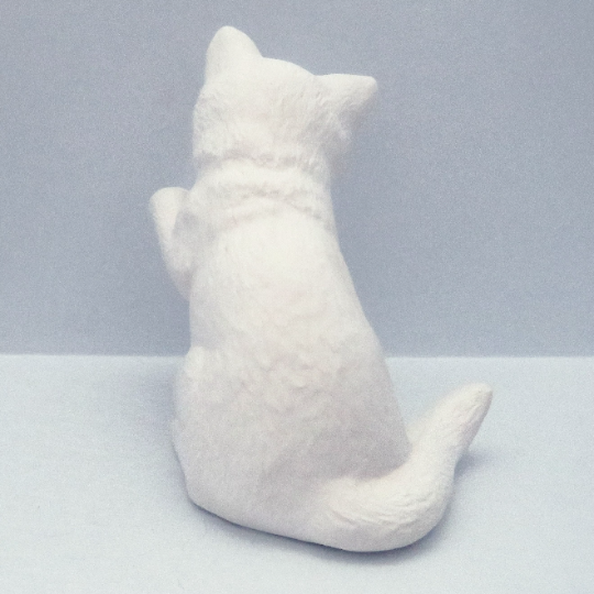 Ready to paint ceramic cat figurine with left front paw up back view.