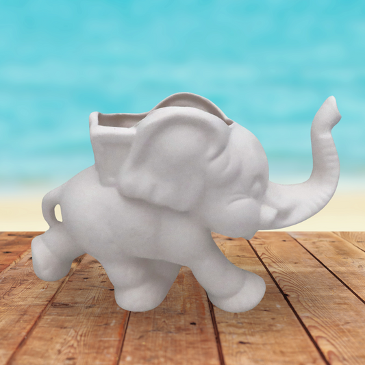 Handmade Ready to paint ceramic elephant pot standing on wooden table by the beach