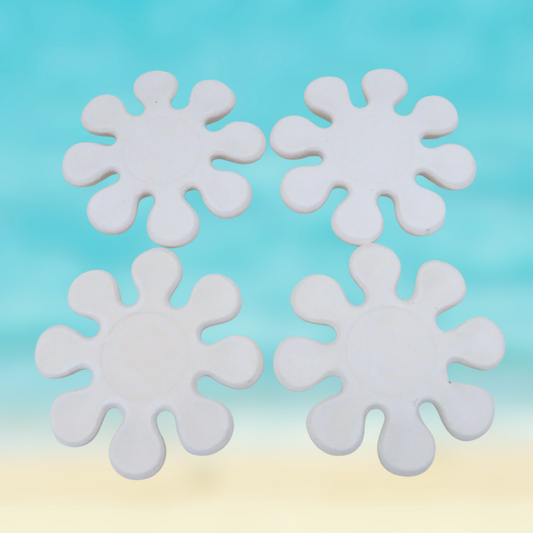 Set of 4 handmade ready to paint ceramic flower shaped coasters against an ocean background.