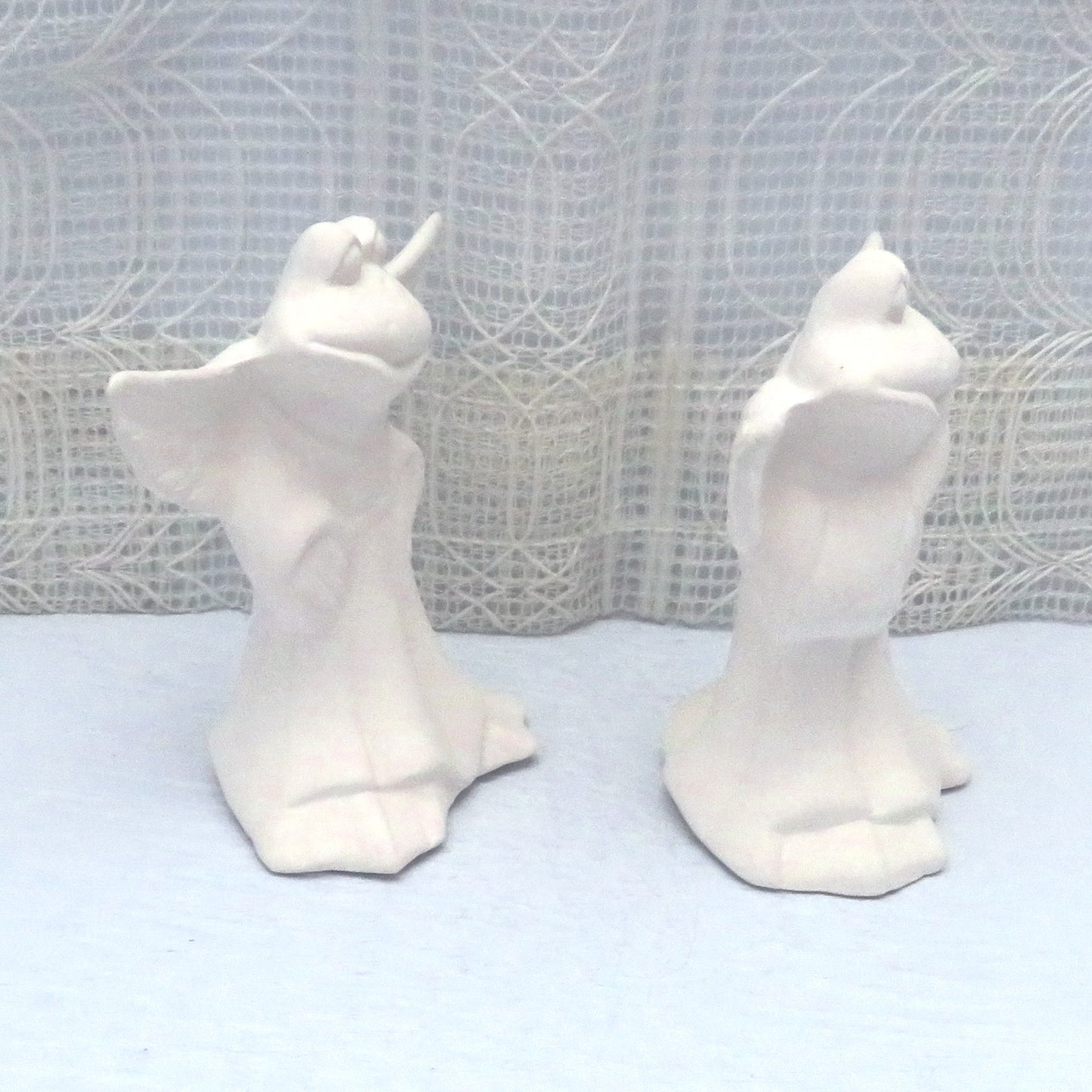 Side view of paintable ceramic frog angel figurines
