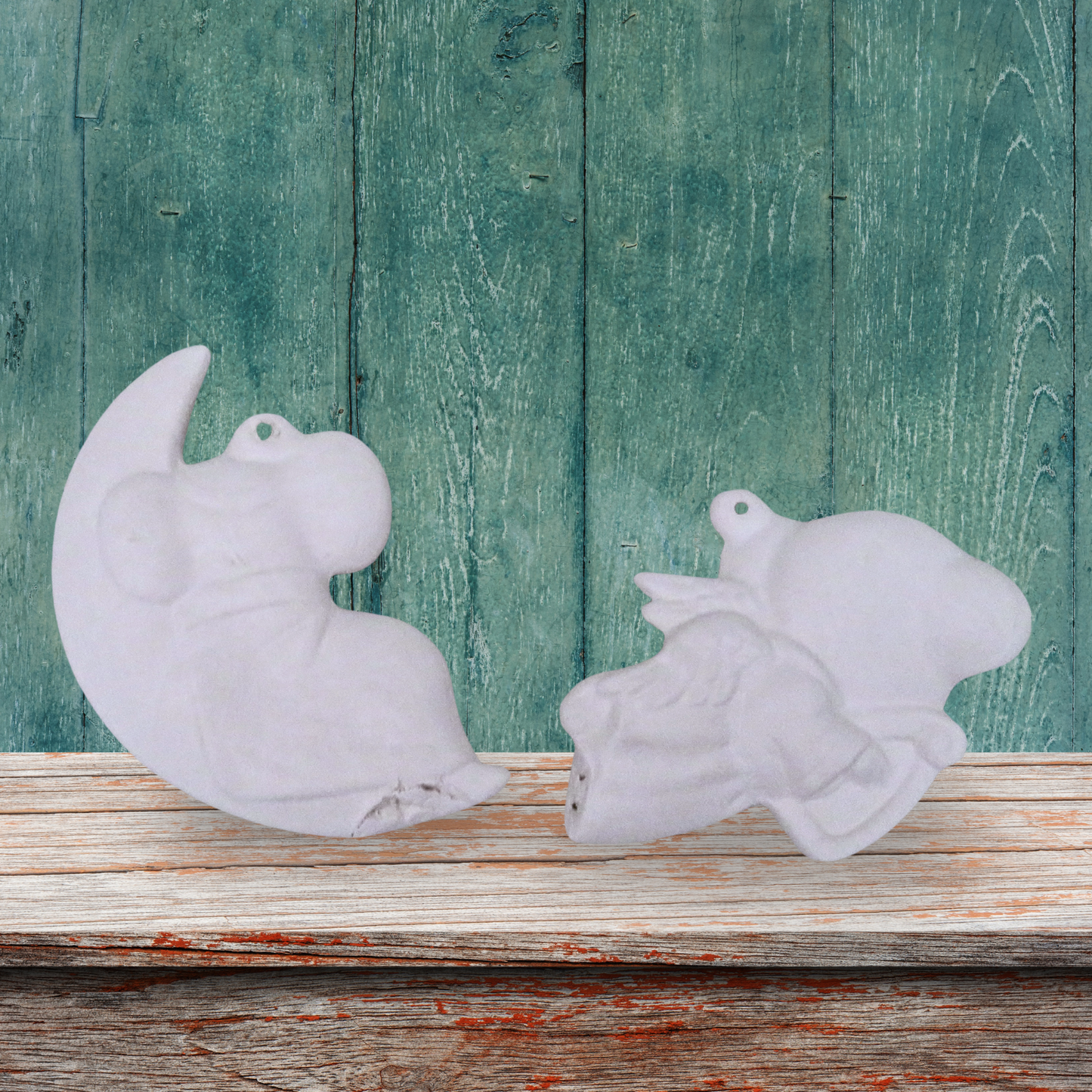 Back view of unpainted ceramic mouse on moon and mouse with harp ornaments on a shelf with a green wood background