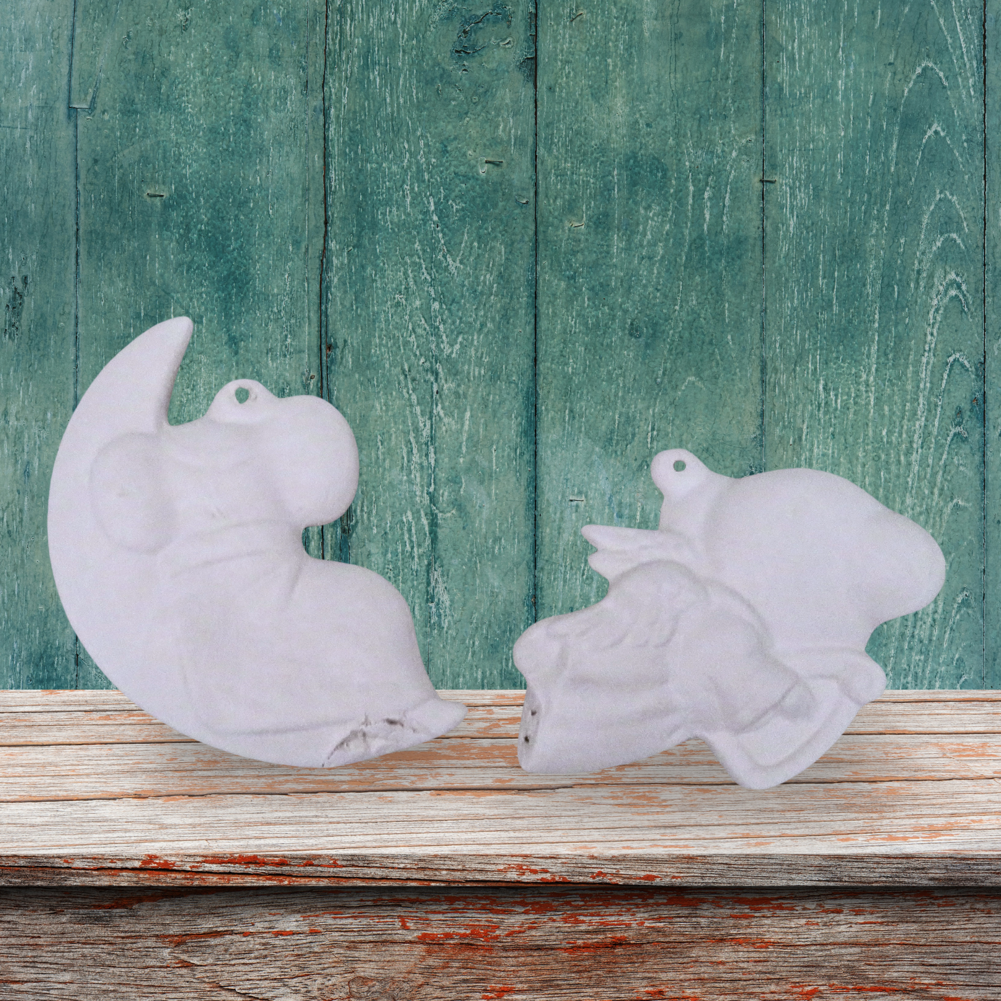 Back view of unpainted ceramic mouse on moon and mouse with harp ornaments on a shelf with a green wood background