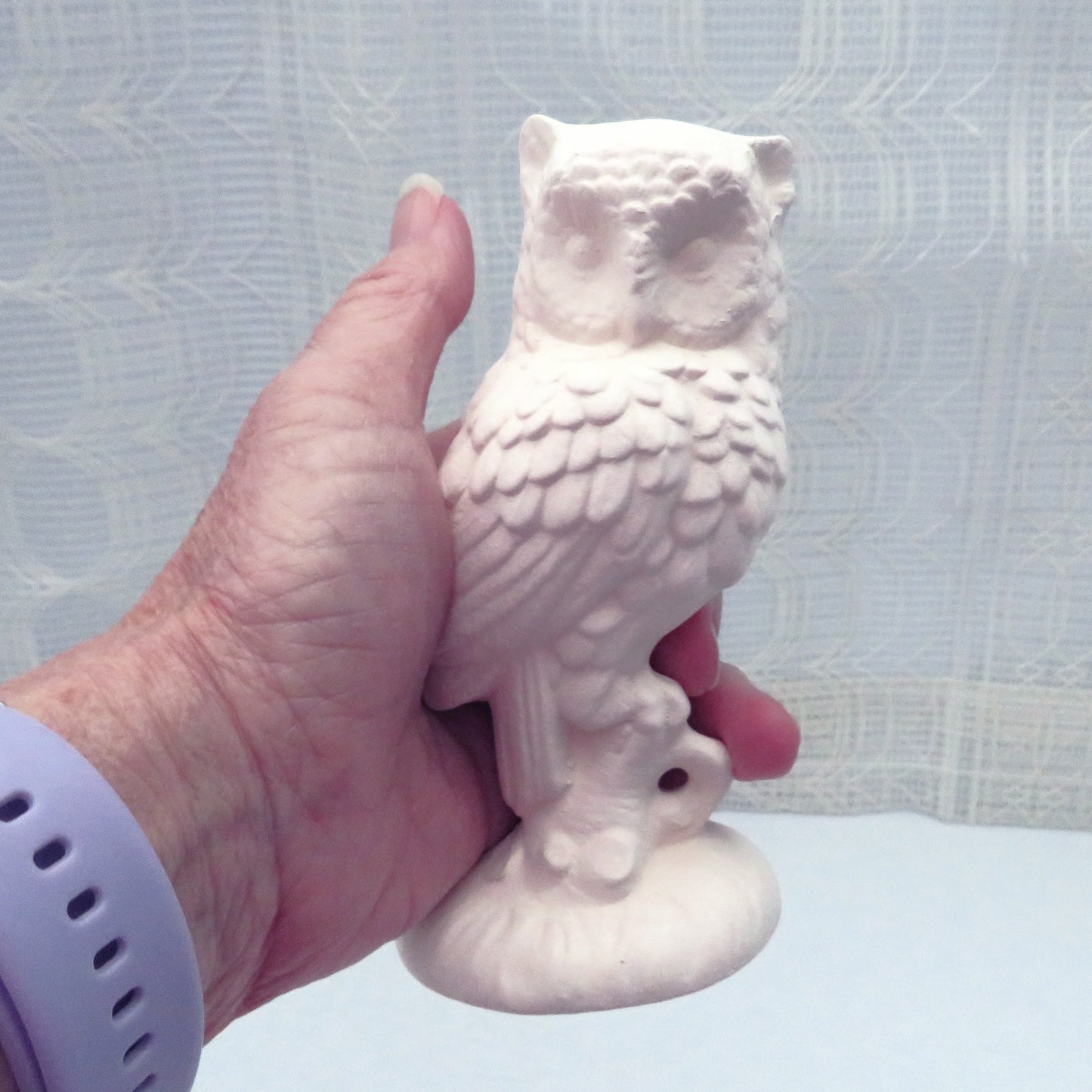 Handmade ceramic owl in my hand for size comparison.