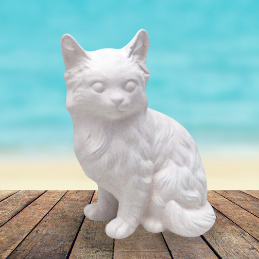 Handmade ceramic ready to paint Sitting Persian cat facing forward with its tail curled around to the front.  He is sitting on a table near the ocean.  This photo shows the texture of the cat.