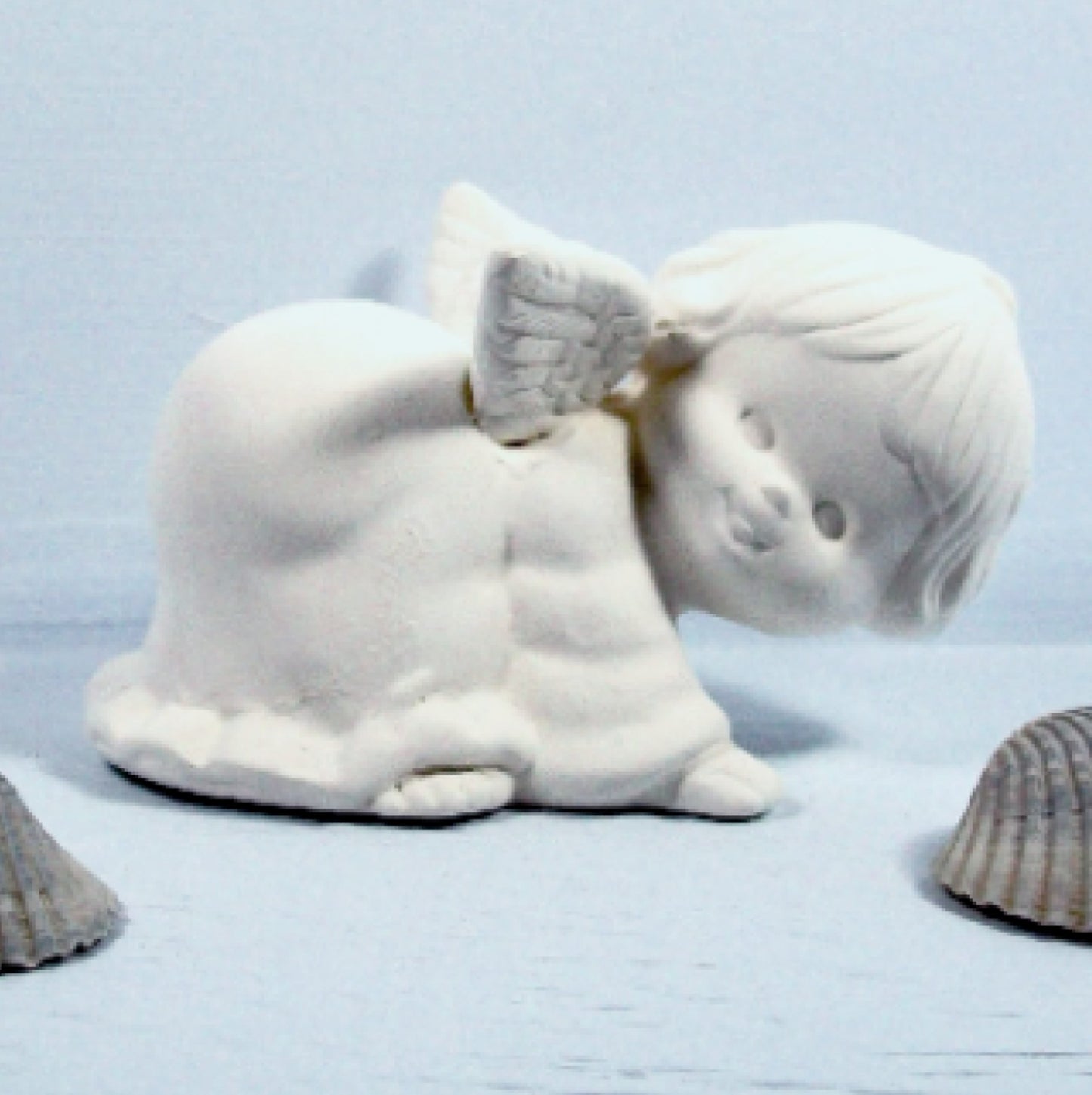 Handmade playful ceramic angel figurine for you to paint.  She is on all 4's with her head to the right.