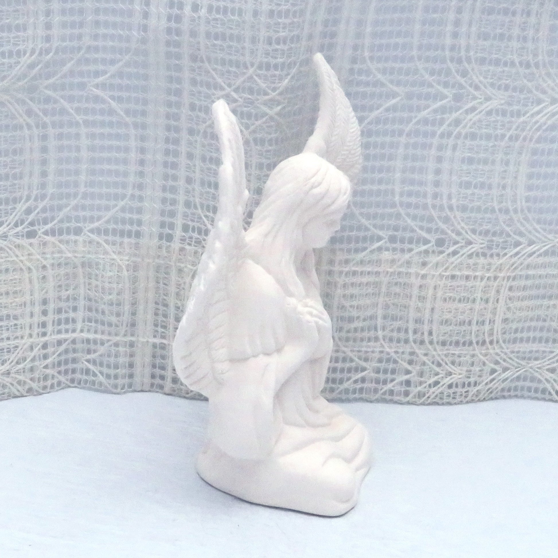 Side view of paintable ceramic angel statue facing right