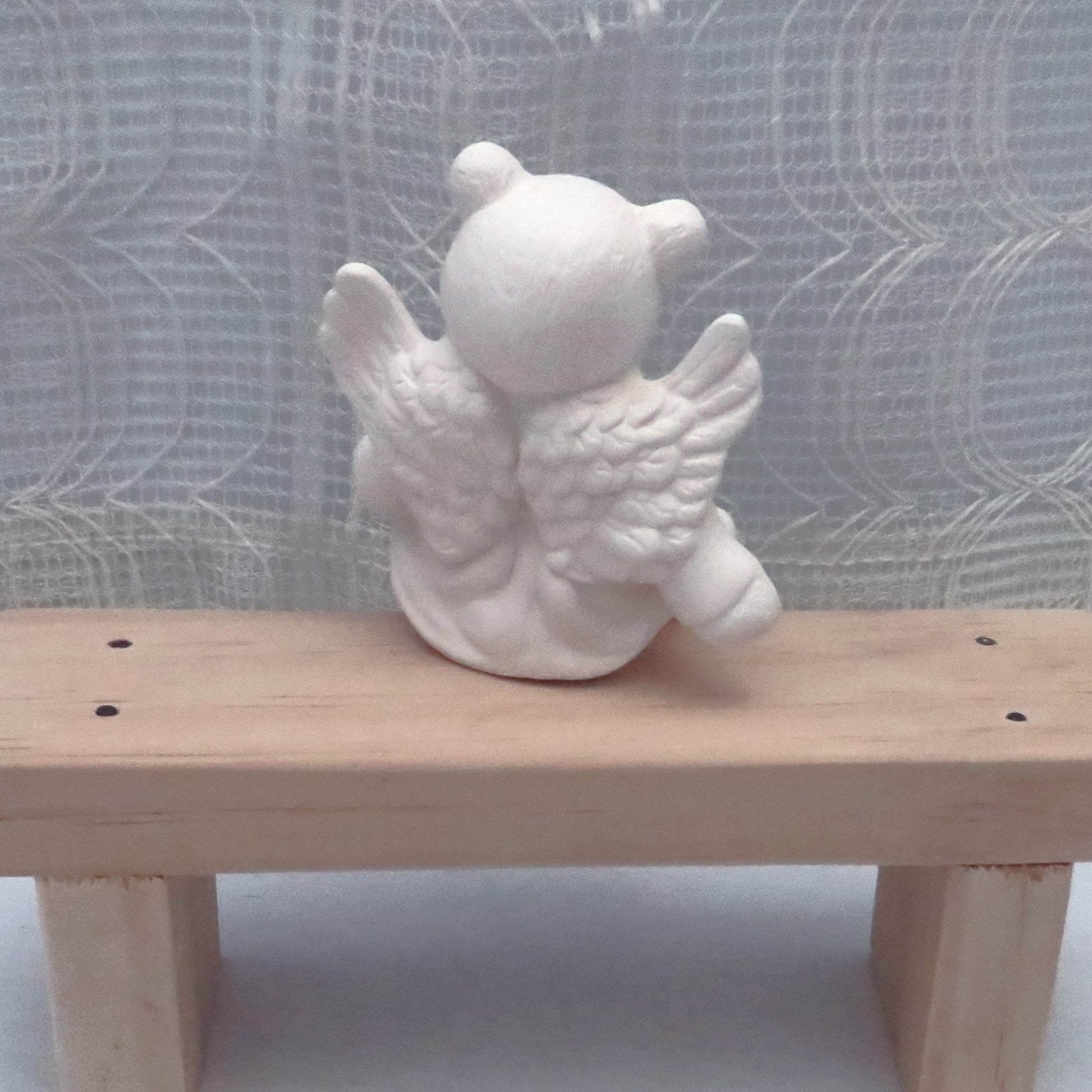 Rear view of paintable ceramic angel bear.  The wings are visible with a lot of detail.