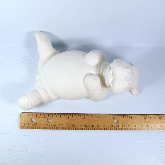 View from above of diy ceramic hippo statue by a ruler showing him to be approximately 7 1/2 inches long.