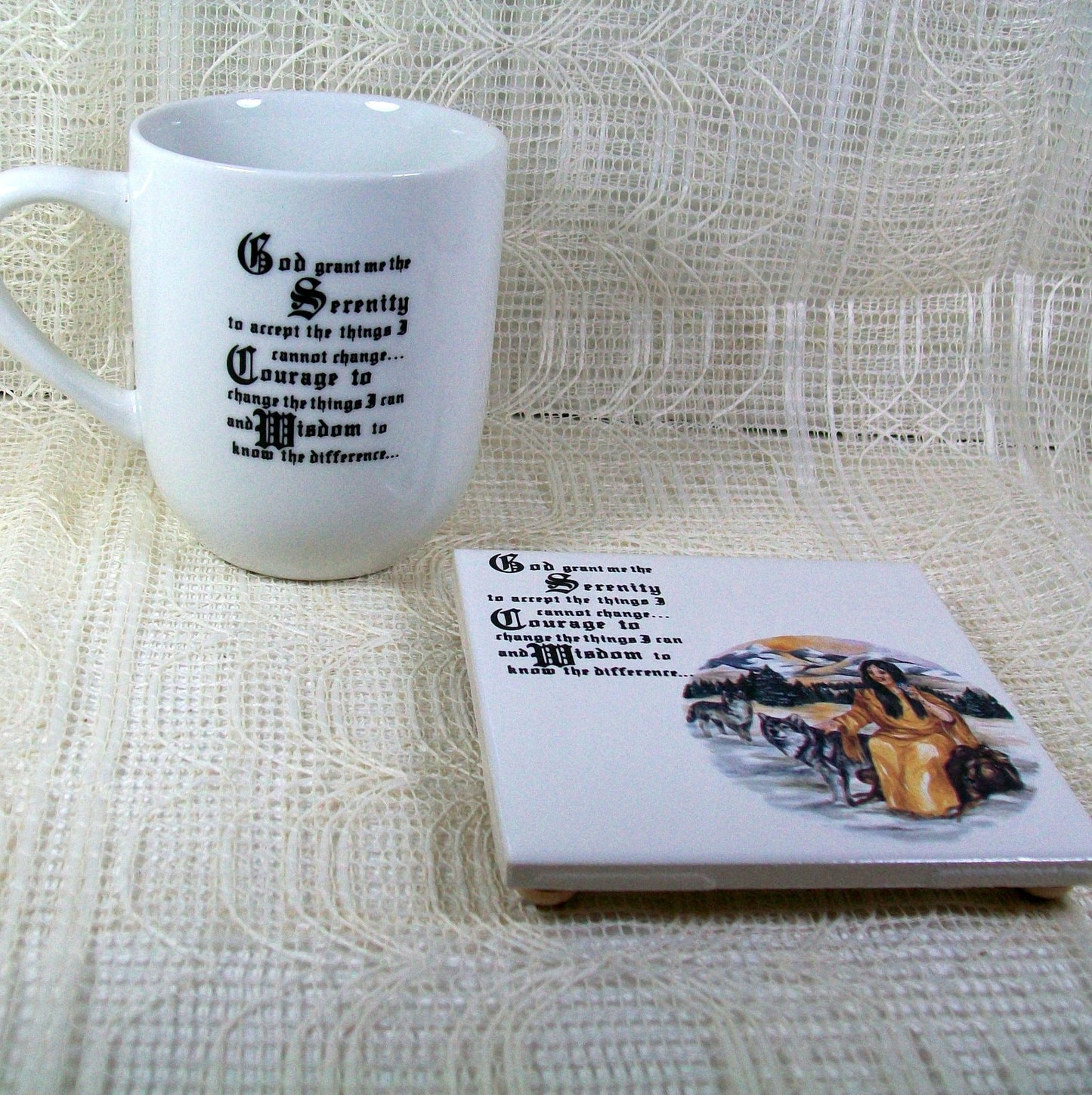 White glossy ceramic mug wtih the handle facing left.  The Serenity prayer is showing on this side of the mug.  The tile coaster is next to the mug with the native American girl and the serentiy prayer.