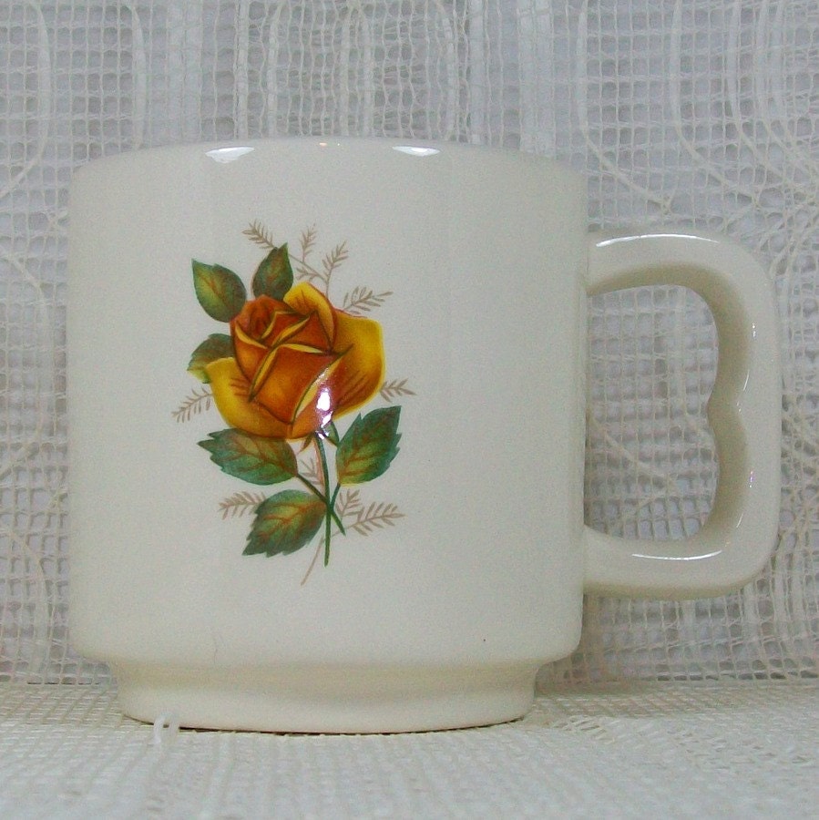 Single white ceramic mug with handle toward the right showing the yellow rose