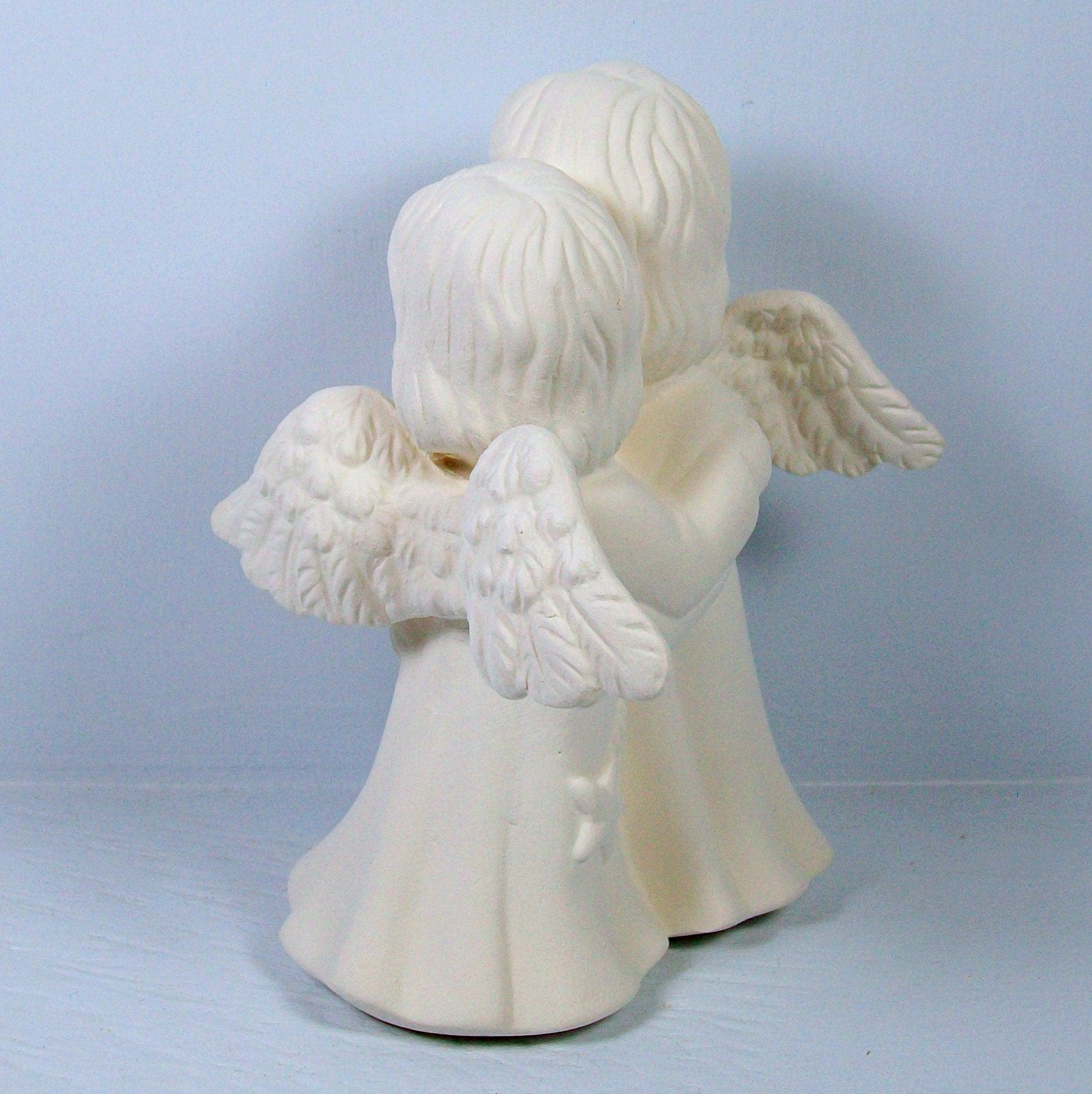 View showing back of smaller paintable ceramic angel figurine