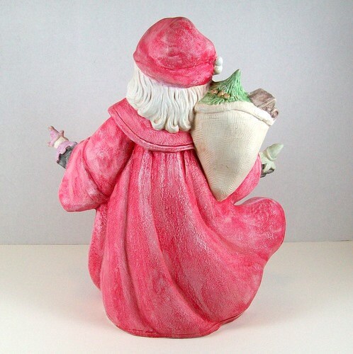 Rear view of ceramic handpainted Santa figurine.  There is a better view of his bag of presents, hair, and flowing robe.