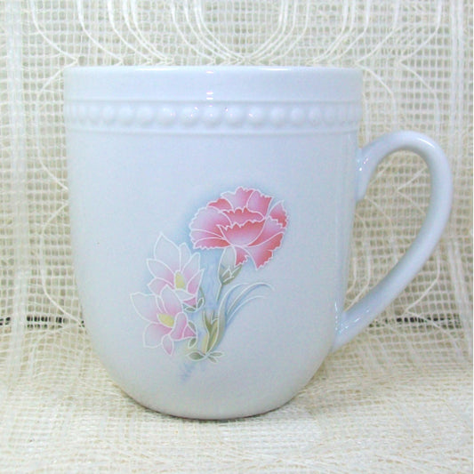 White mug with pink flower on lacy background