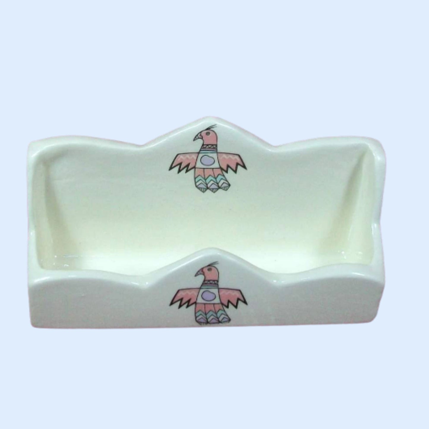 View of white glazed ceramic business card holder showing the space inside and the thunder bird decals